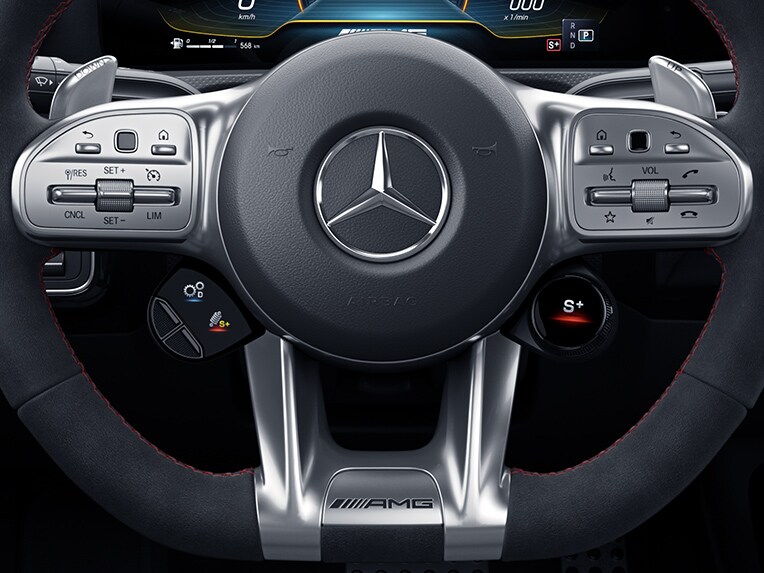 The image shows the Mercedes-AMG A 35 4MATIC Saloon with AMG steering wheel buttons.