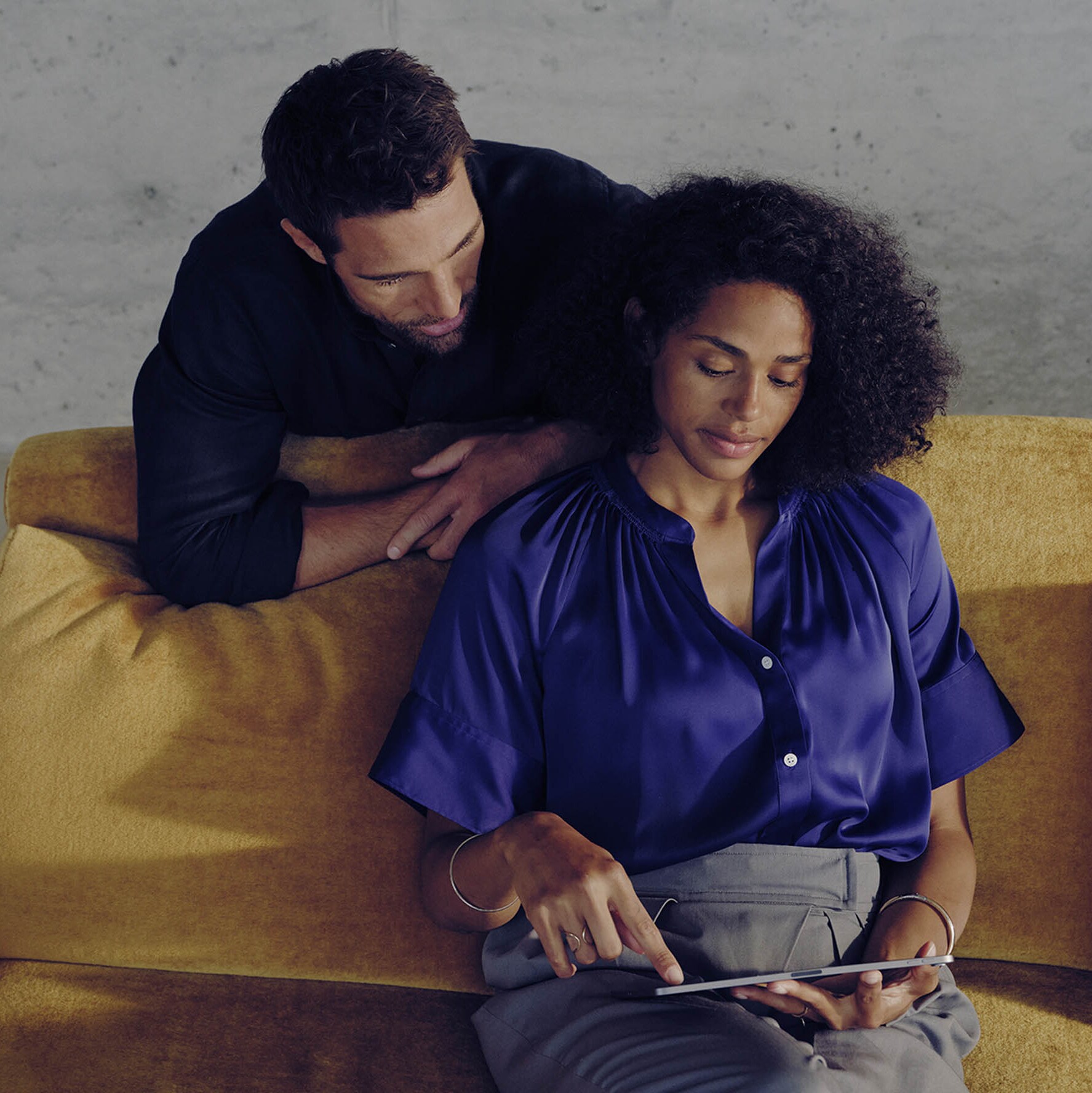 Husband and wife looking at a tablet together