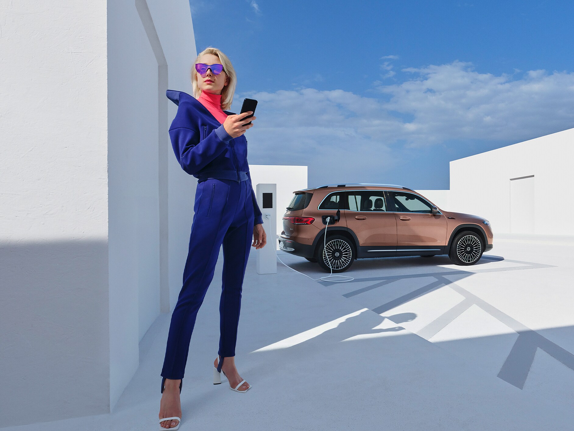 Woman connecting her smartphone to her vehicle to use the Standard Services.