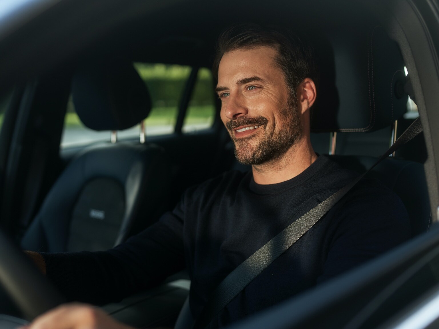 Man enjoying uninterrupted internet radio in his Mercedes-Benz thanks to the Entertainment Package.